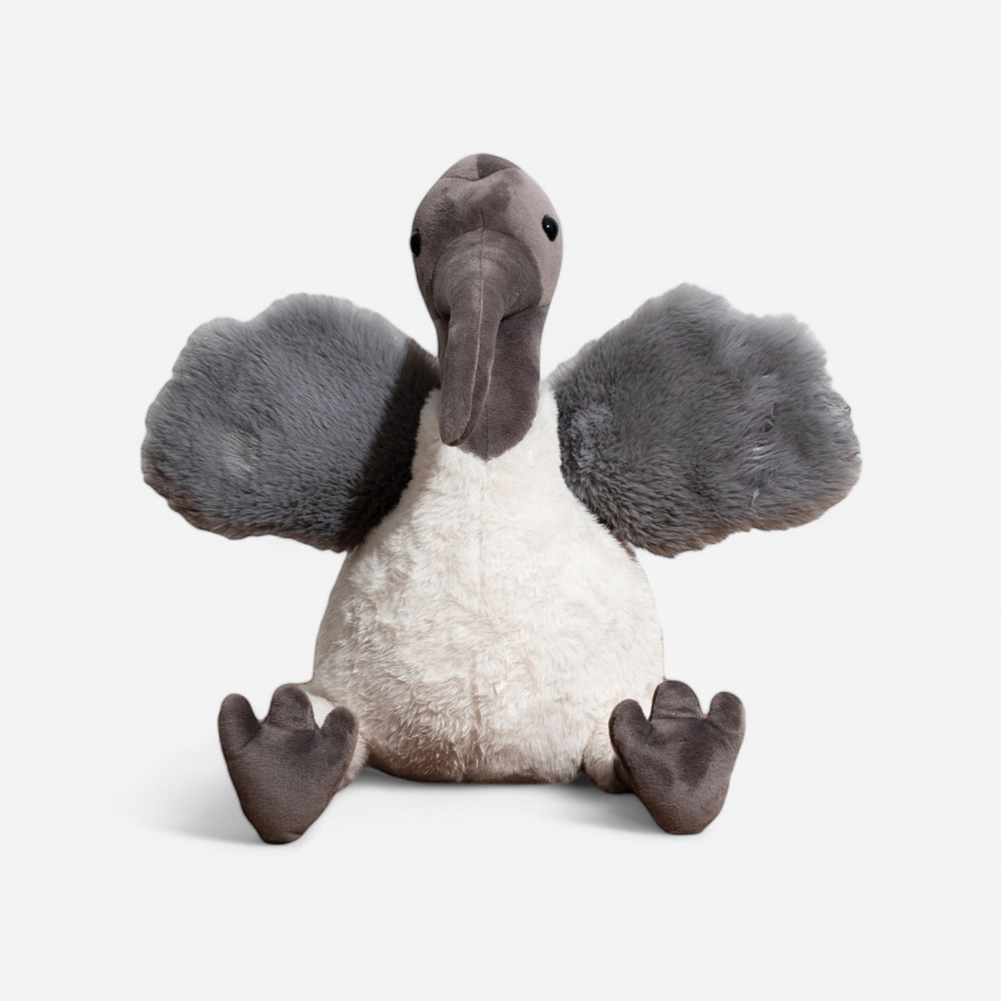 Plush toy ibis with gray wings and white body on a light gray background