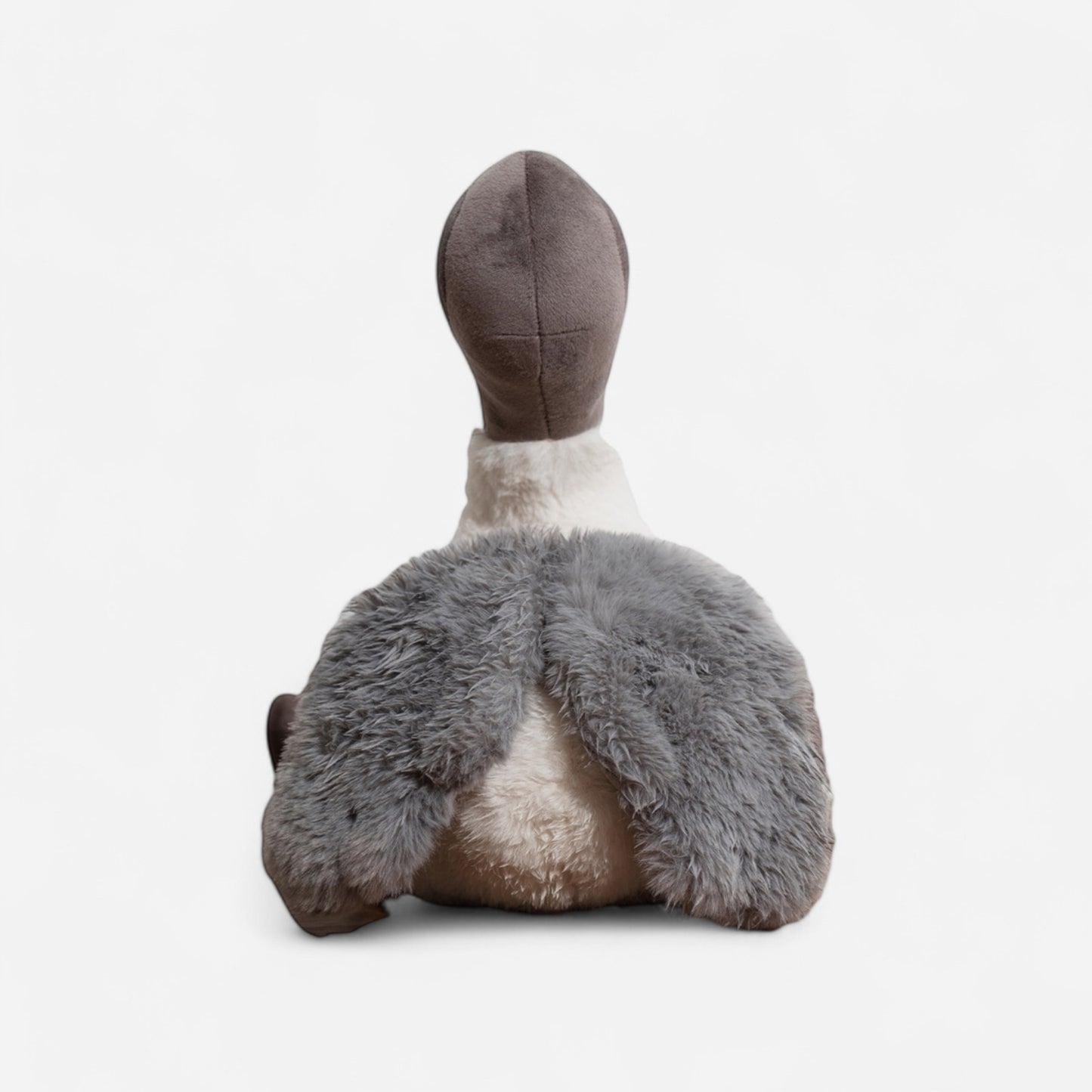 Plush toy bird (Ibis) or bin chicken with grey feathers and a white body on a white background