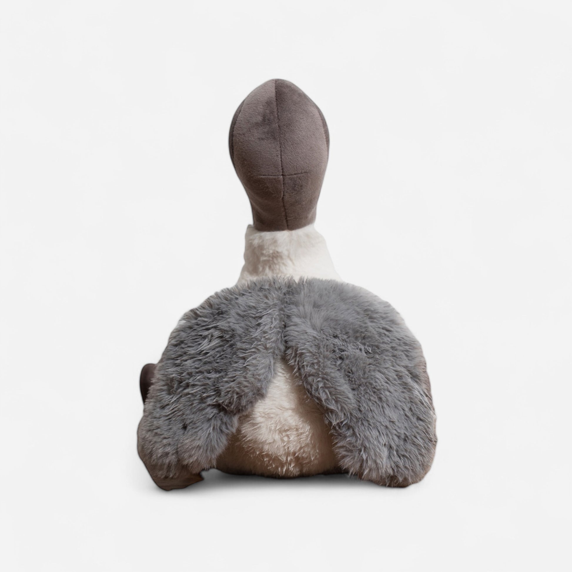 Plush toy bird (Ibis) or bin chicken with grey feathers and a white body on a white background